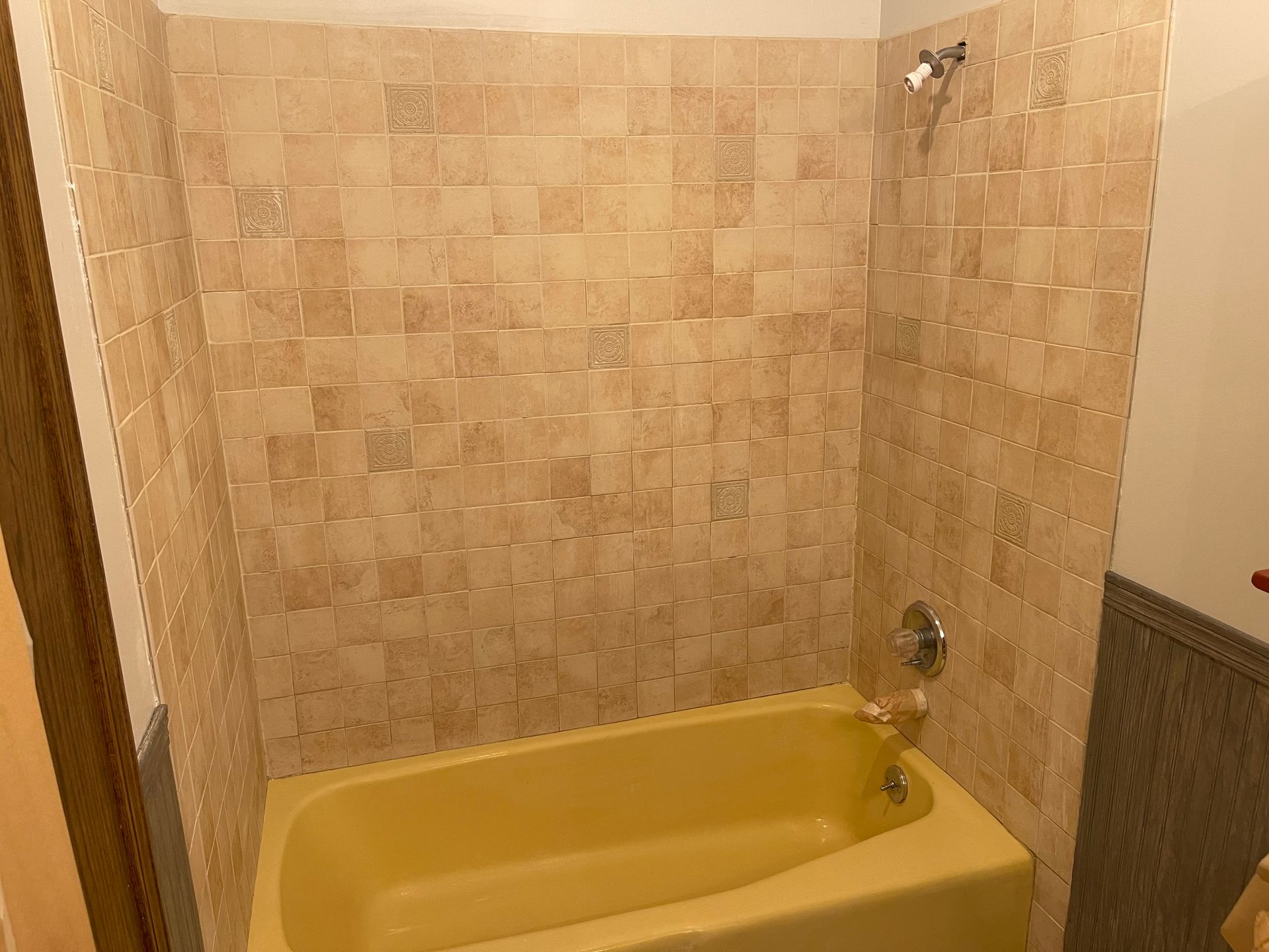 A bathroom with a yellow bathtub and a shower - before