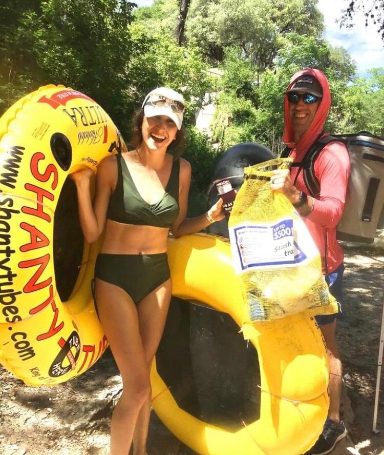 A woman in a bikini is holding a yellow shanty tube