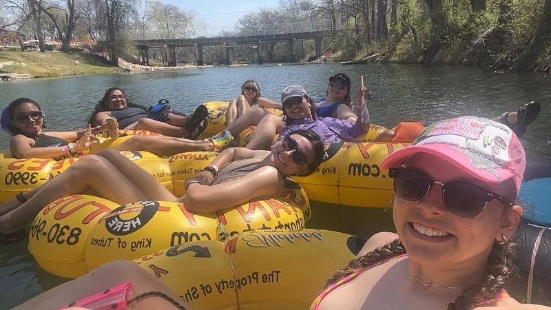 A group of people are floating on rafts on a river.