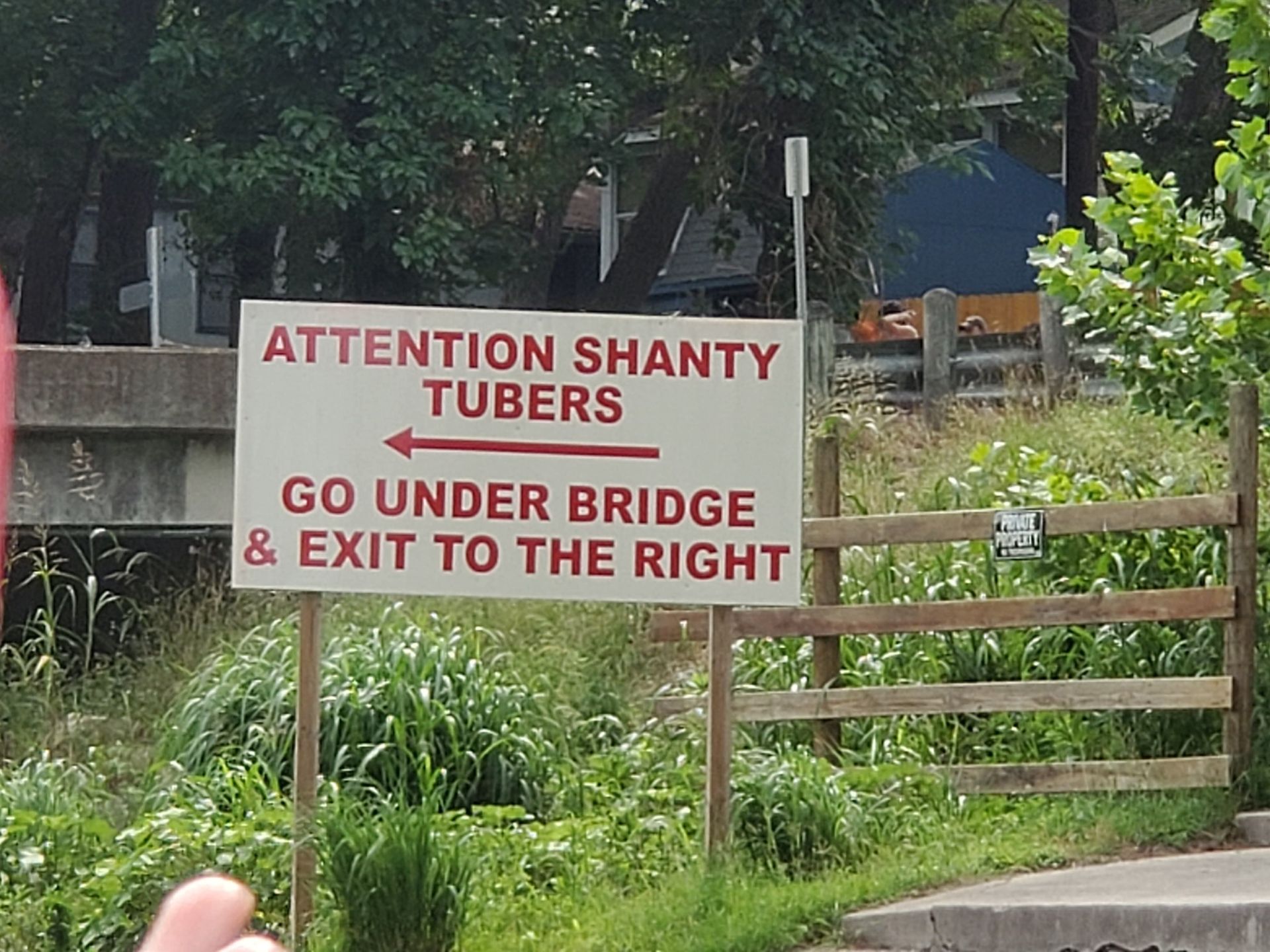 A sign that says attention shanty tubers go under bridge and exit to the right