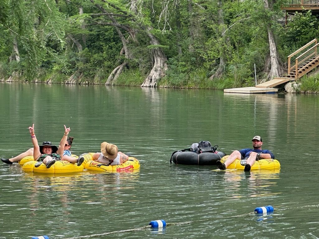 A group of people are floating on rafts in a lake.
