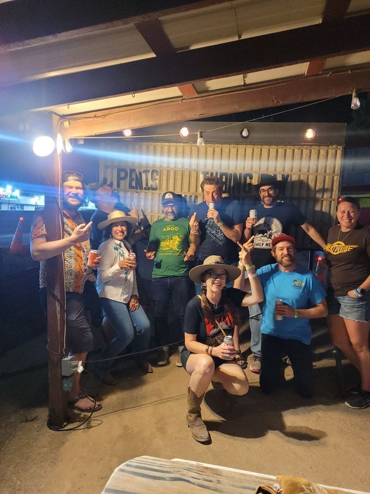 A group of people are posing for a picture in front of a building.