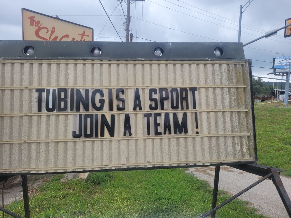 A sign that says tubing is a sport join a team