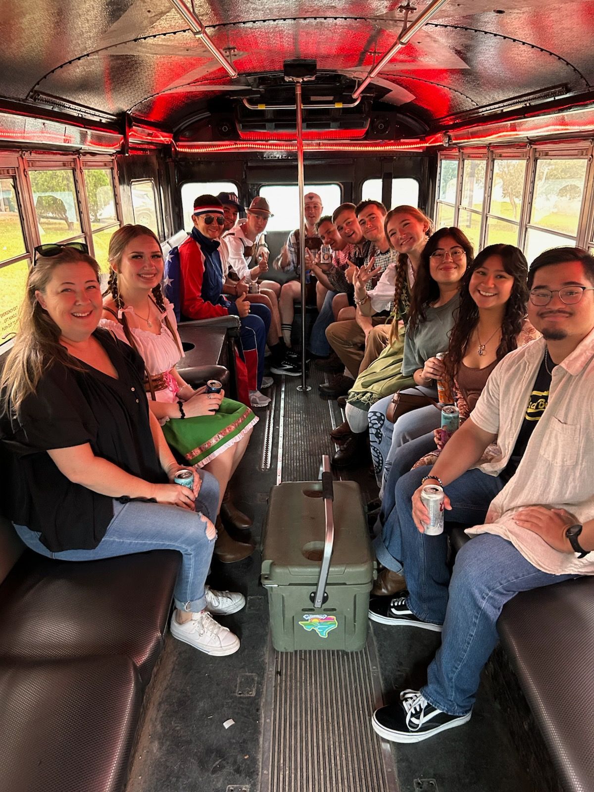 A group of people are sitting on the back of a bus.