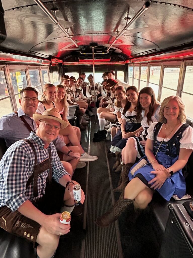 A group of people are sitting on the back of a bus.