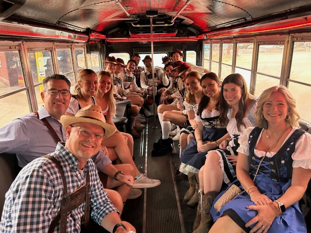 A group of people are sitting on the back of a bus.
