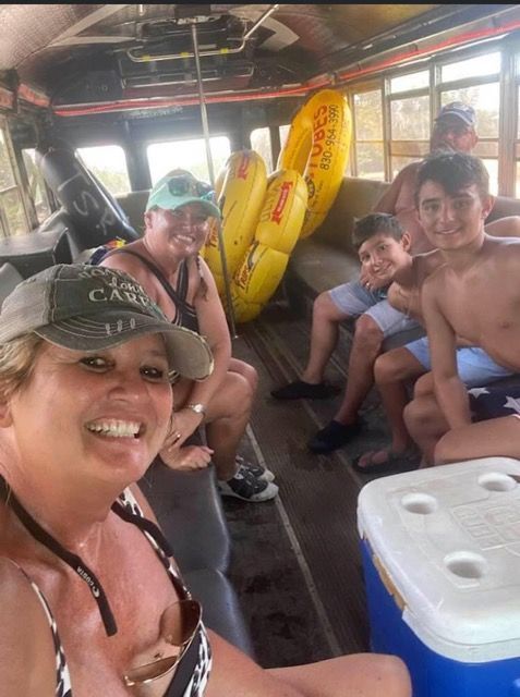 A group of people are sitting on the back of a bus