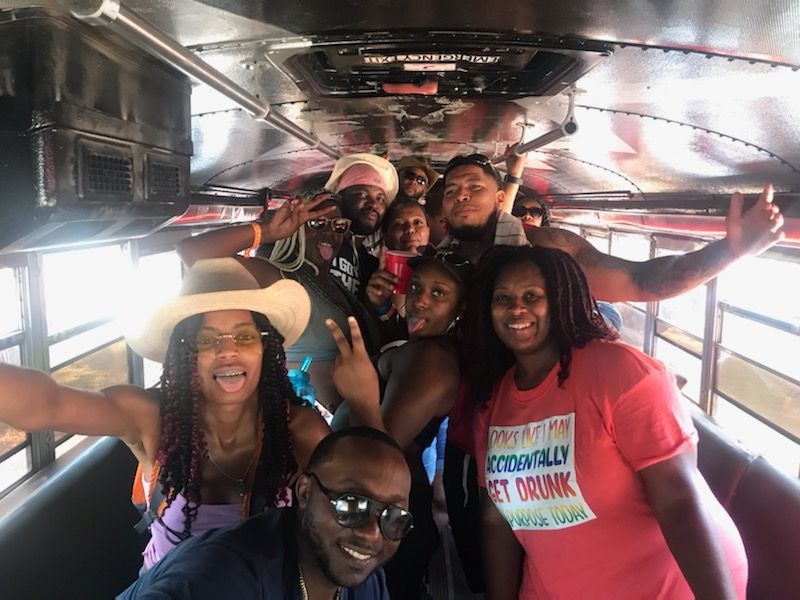 A group of people are posing for a picture on a bus.