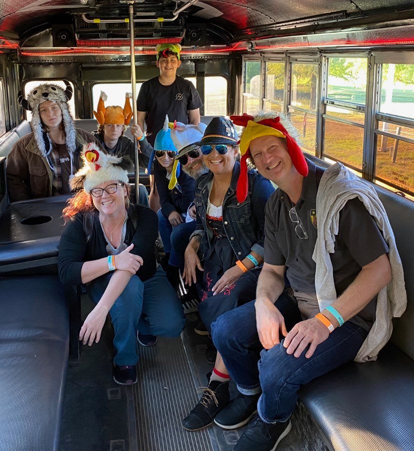 A group of people wearing hats are sitting on a bus.