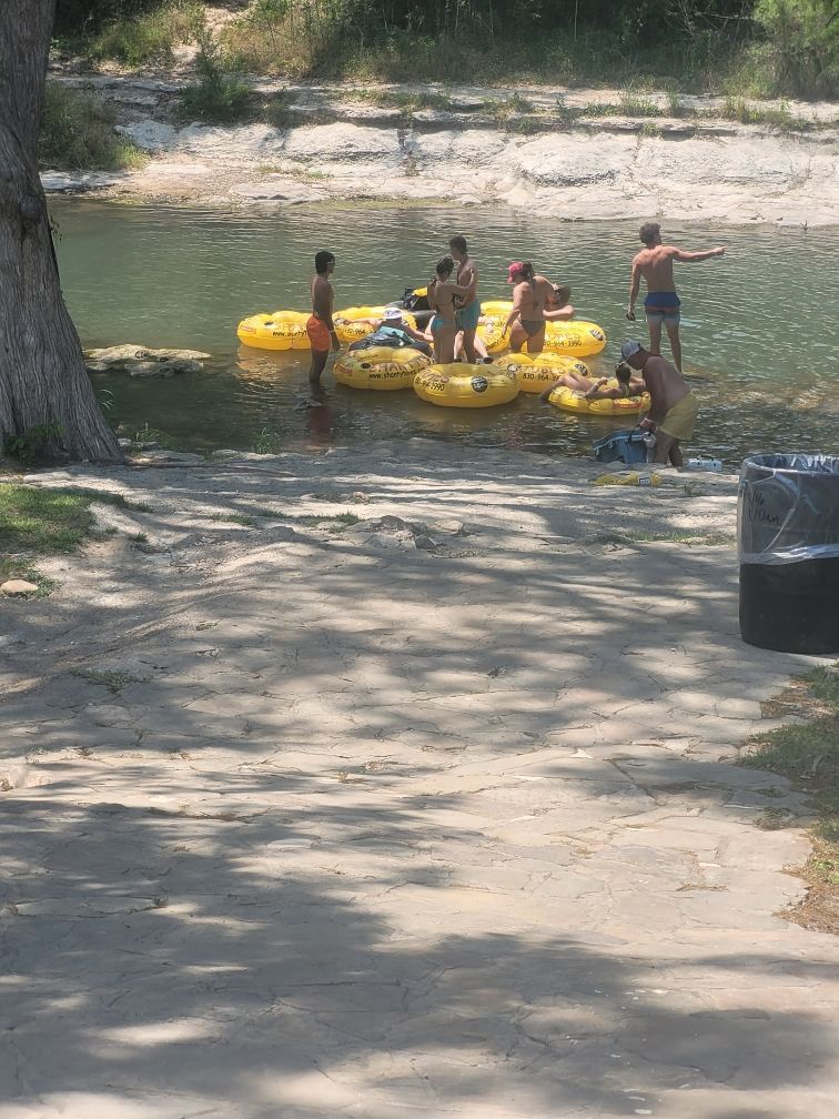 A group of people are standing on rafts in the water.