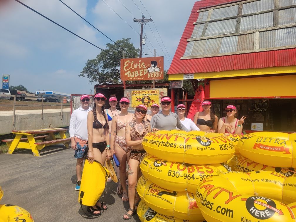 A group of people posing for a picture in front of elvis tuesday