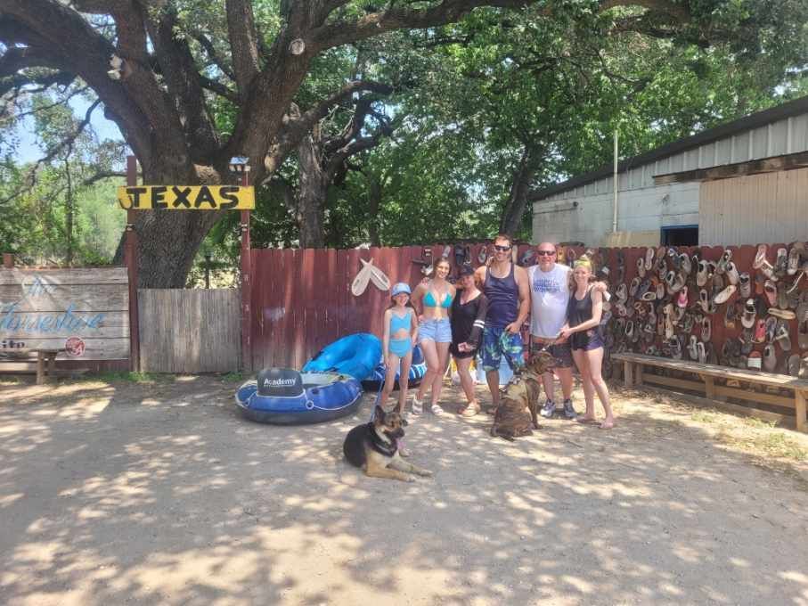 A group of people standing in front of a sign that says texas