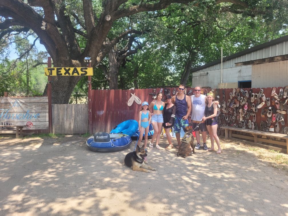 A group of people standing in front of a texas sign.