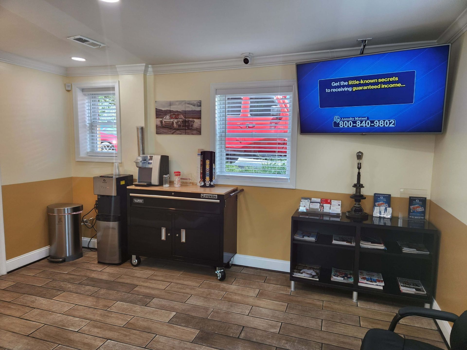 Waiting room with TV, water cooler, cabinets, and a window.
