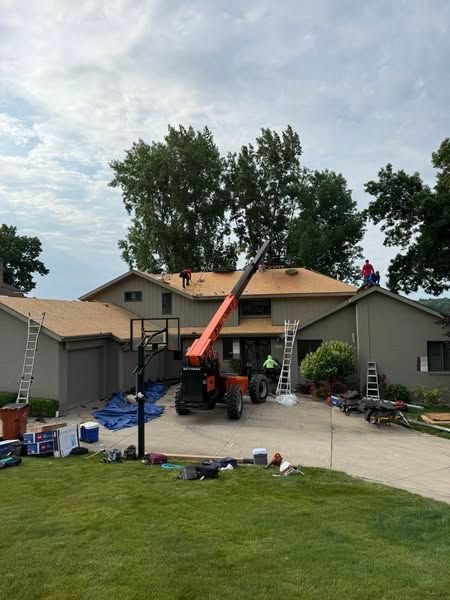 A large house with a crane in front of it.