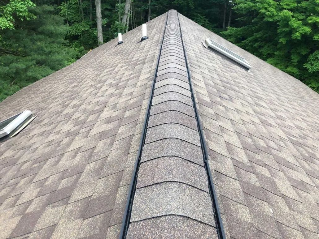 A close up of a roof with a row of skylights on it.