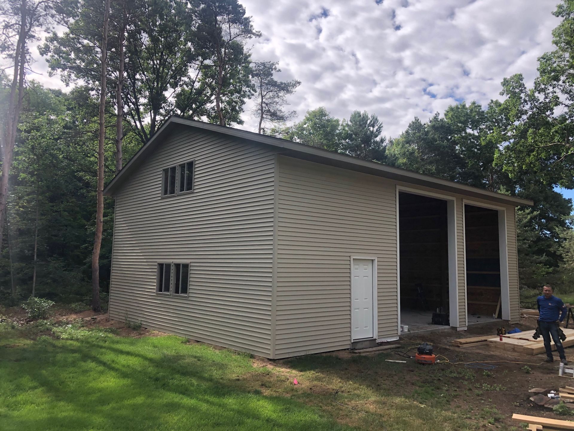 A man is standing in front of a building that is being built.