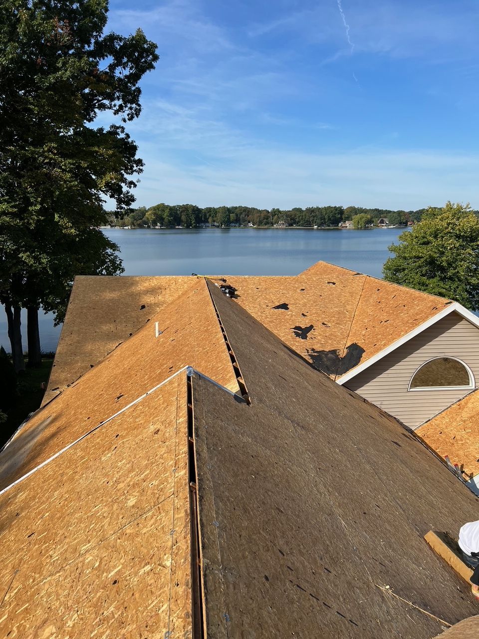 The roof of a house with a lake in the background