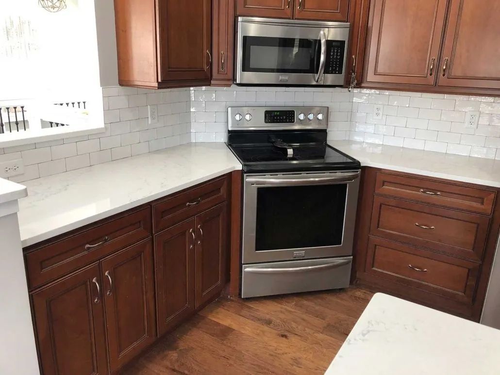A kitchen with stainless steel appliances and wooden cabinets.