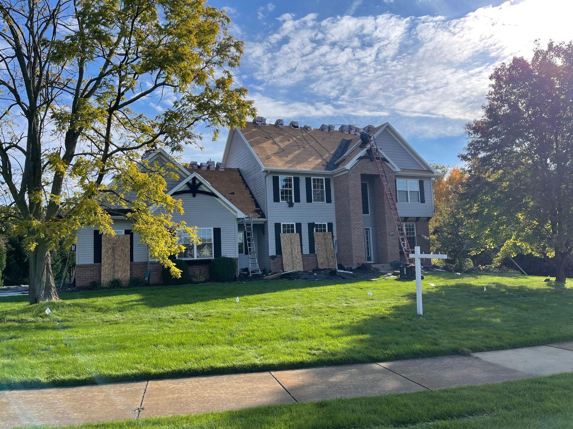 A large house with a roof that has been damaged by a fire.