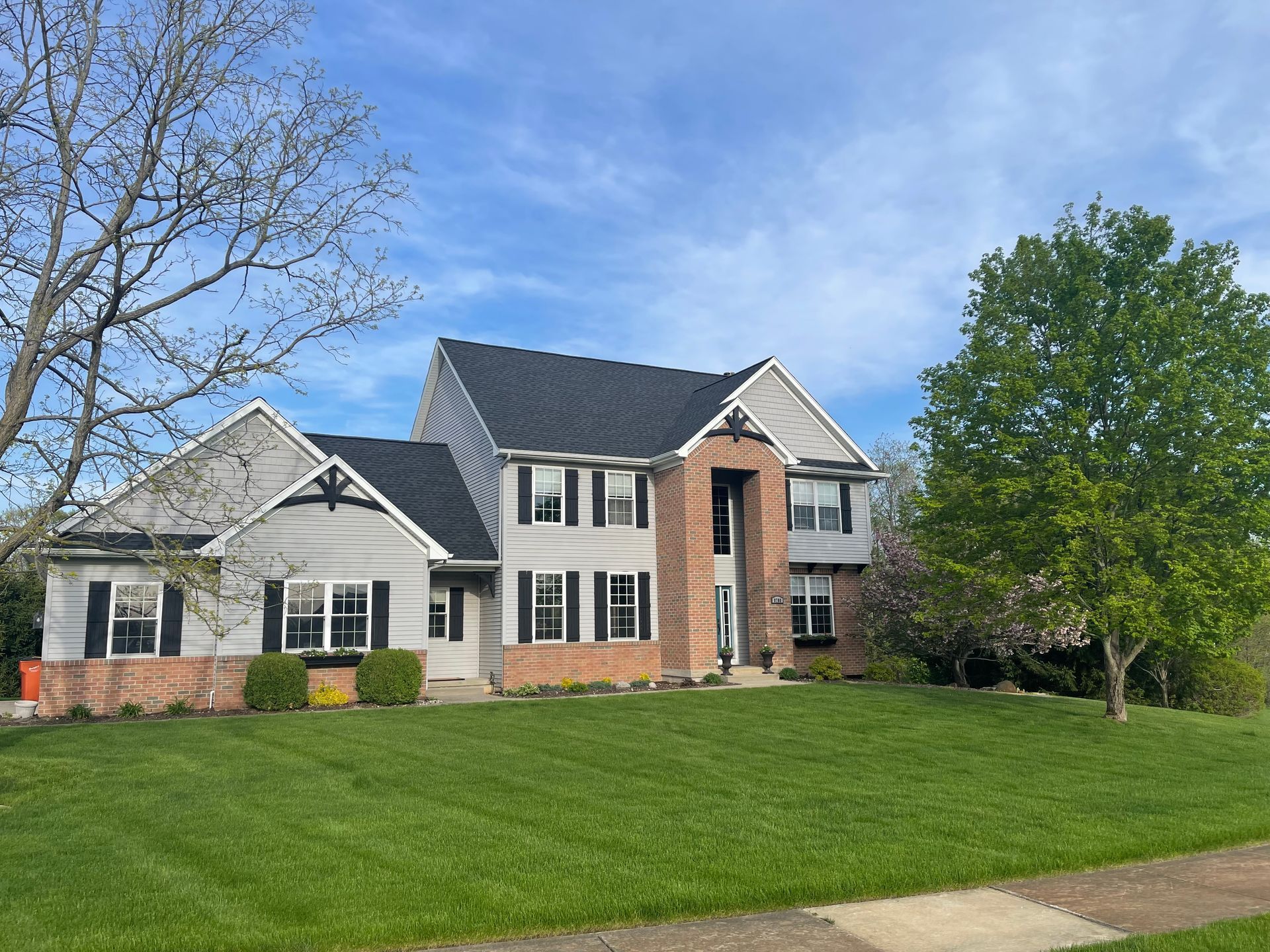 A large house with a lush green lawn in front of it.