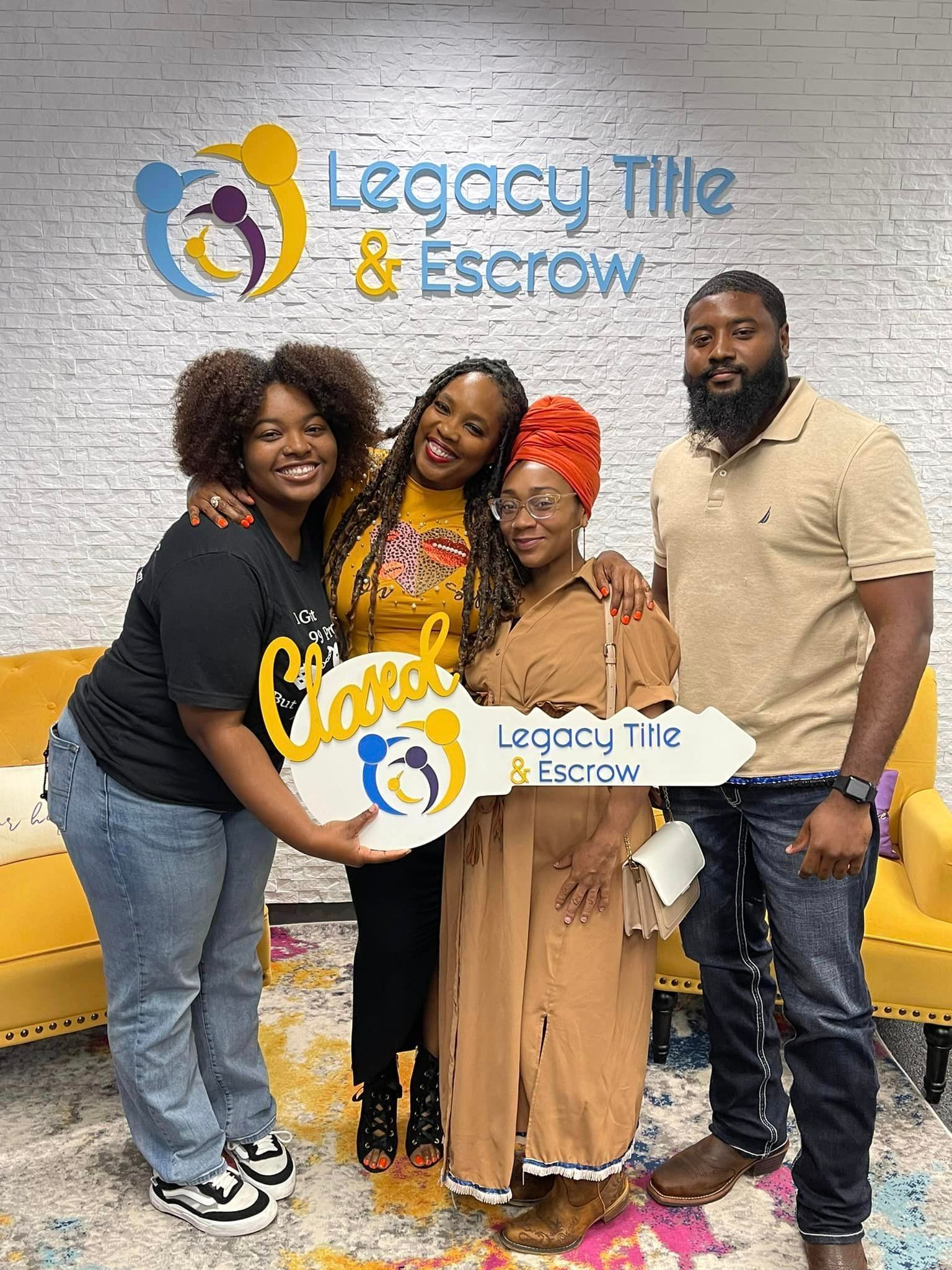 A group of people standing next to each other holding a key.