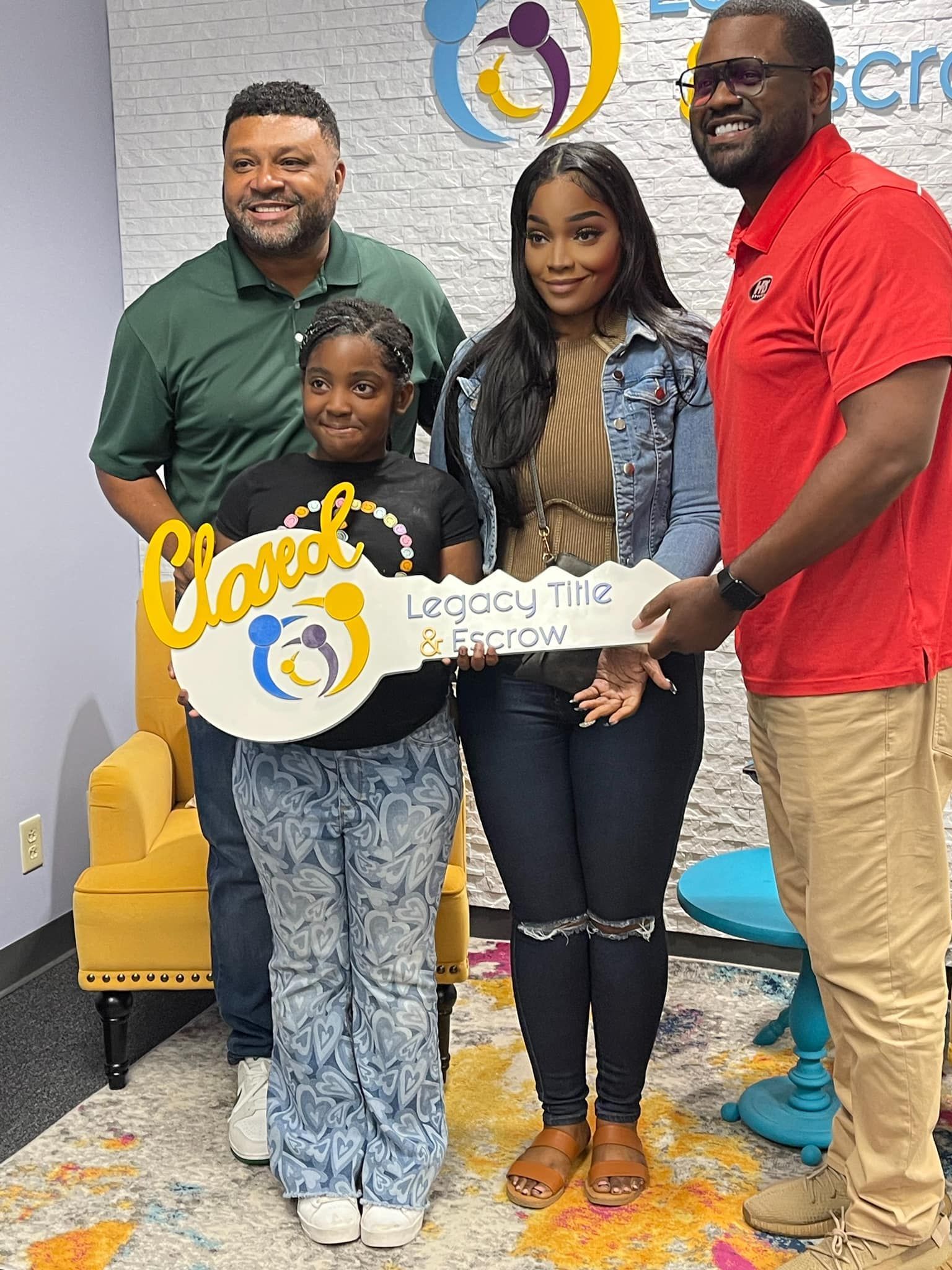 A group of people standing next to each other holding a key.