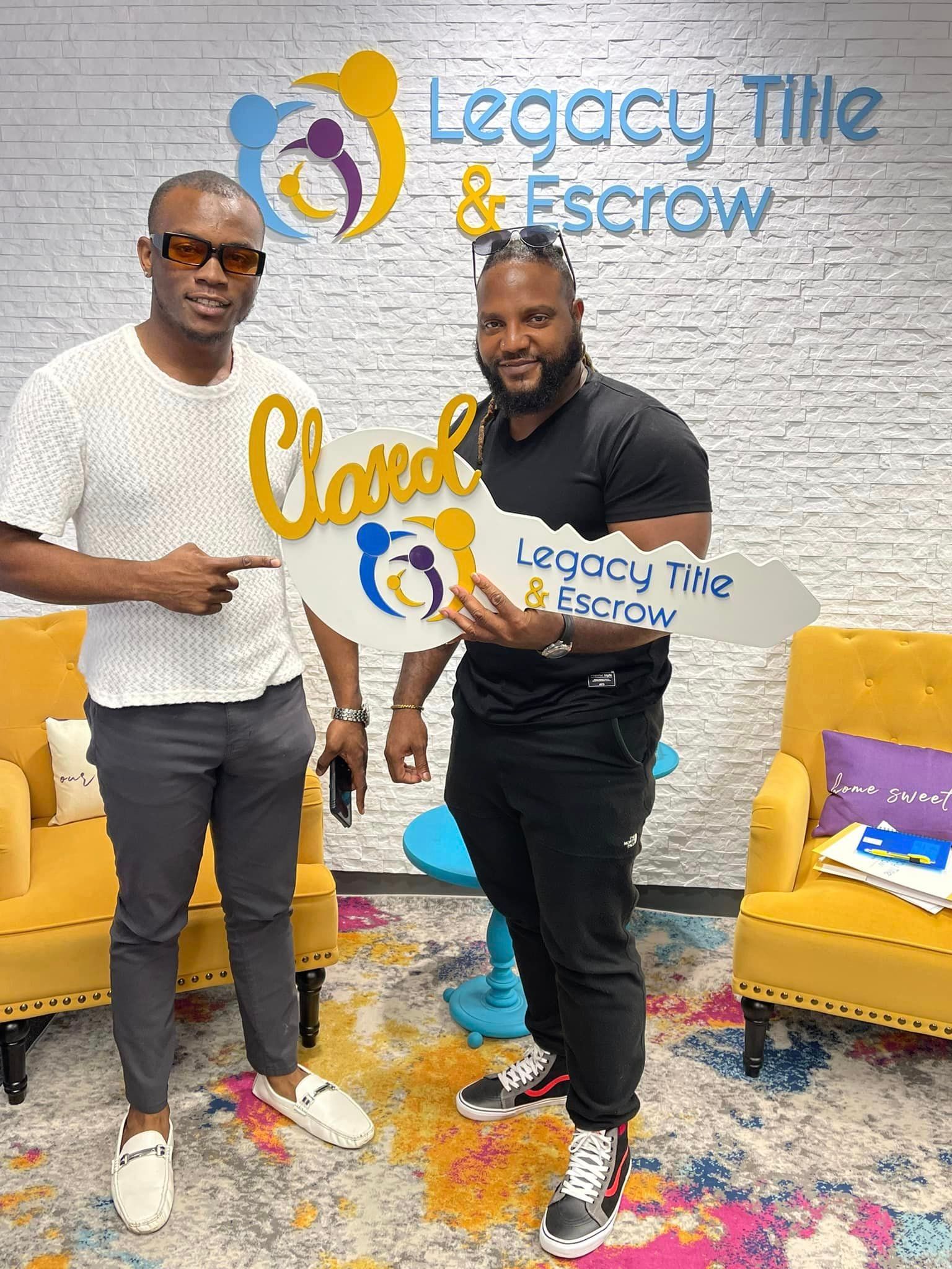 Two men are standing next to each other in a room holding keys.