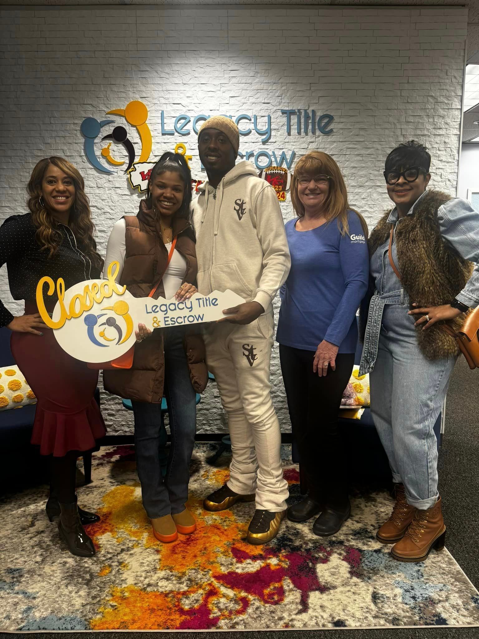 A group of people standing next to each other holding keys.