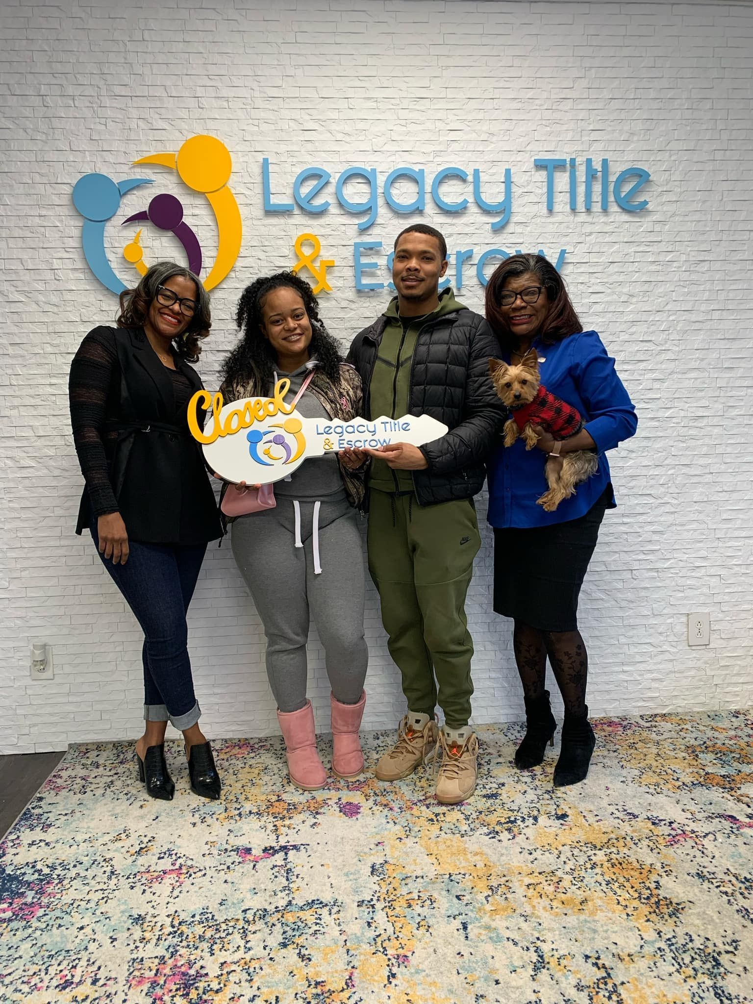 A group of people standing next to each other holding a key.