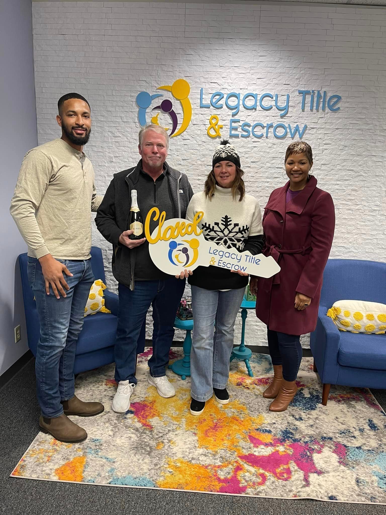 A group of people are standing in a room holding a key.