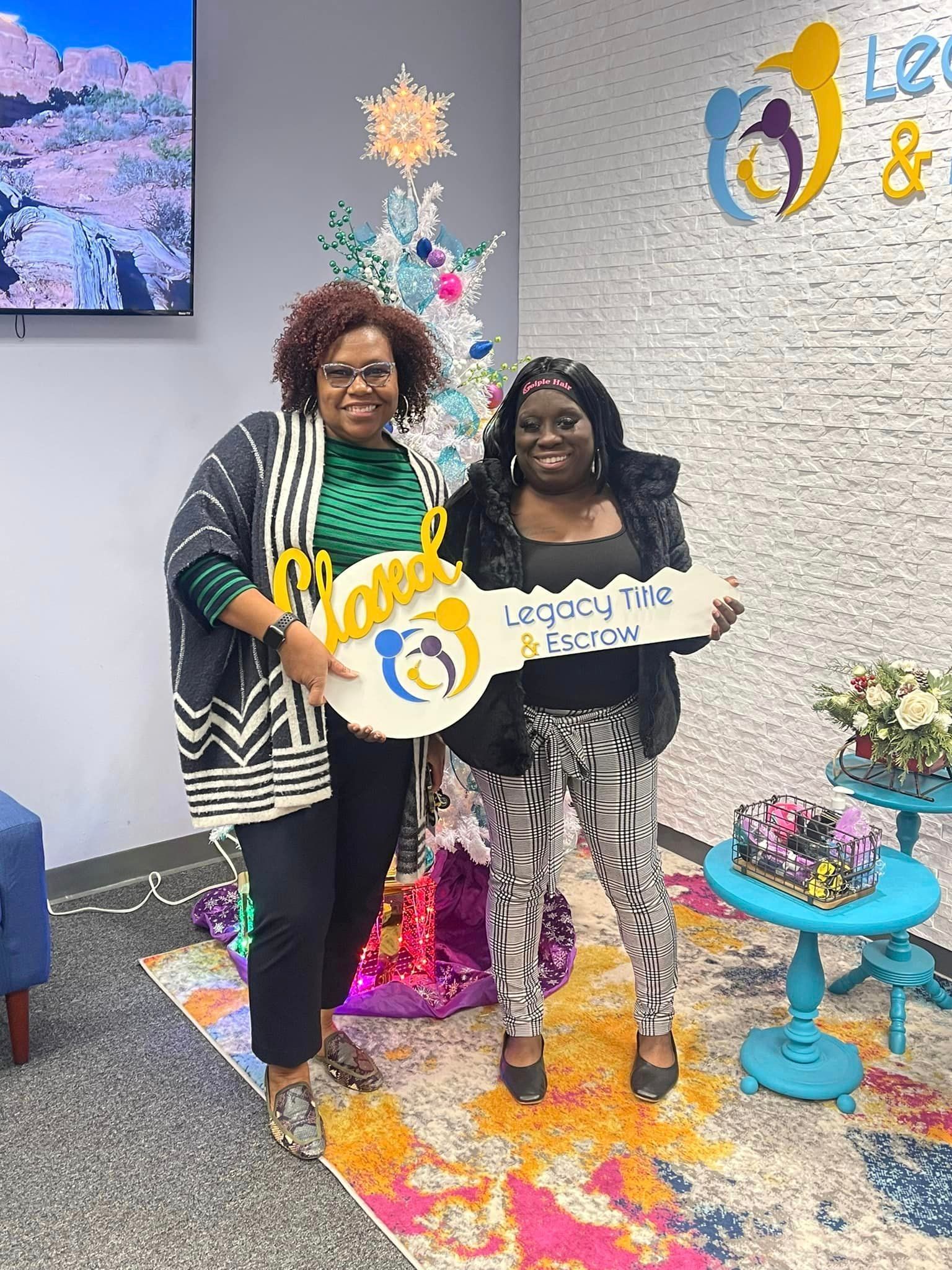 Two women are standing next to each other in a room holding keys.