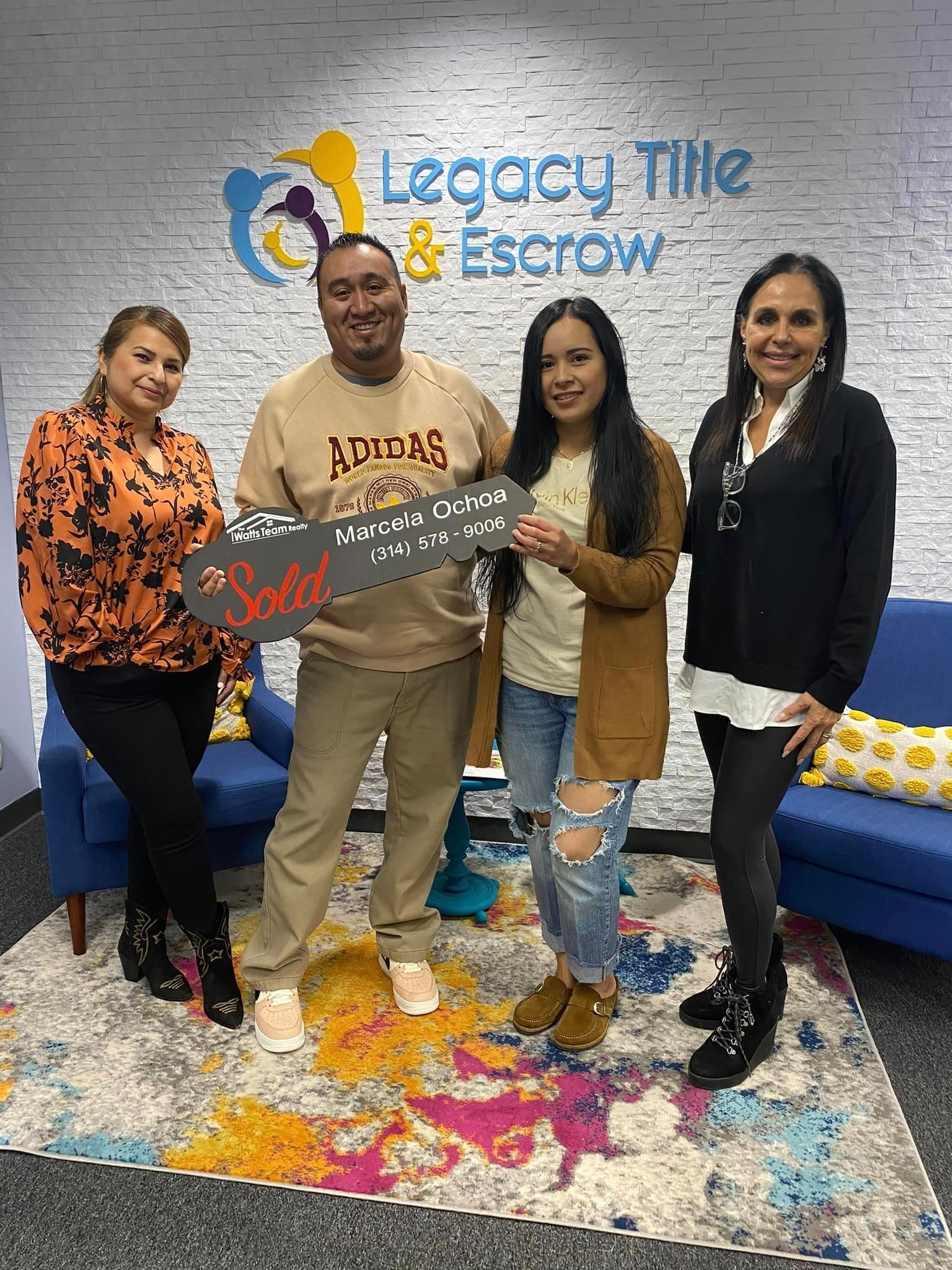 A group of people are standing next to each other in a room.