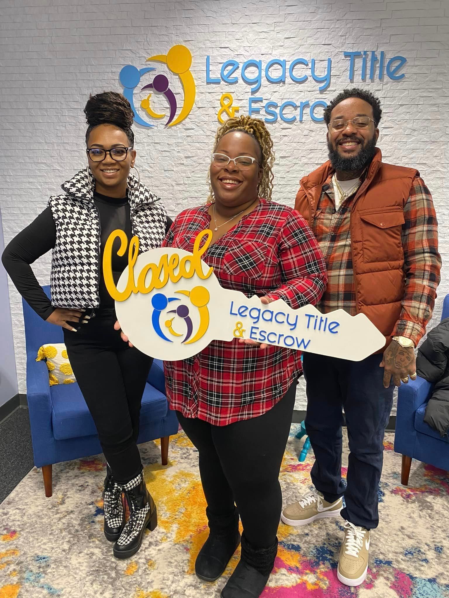 A group of people standing next to each other holding a key.