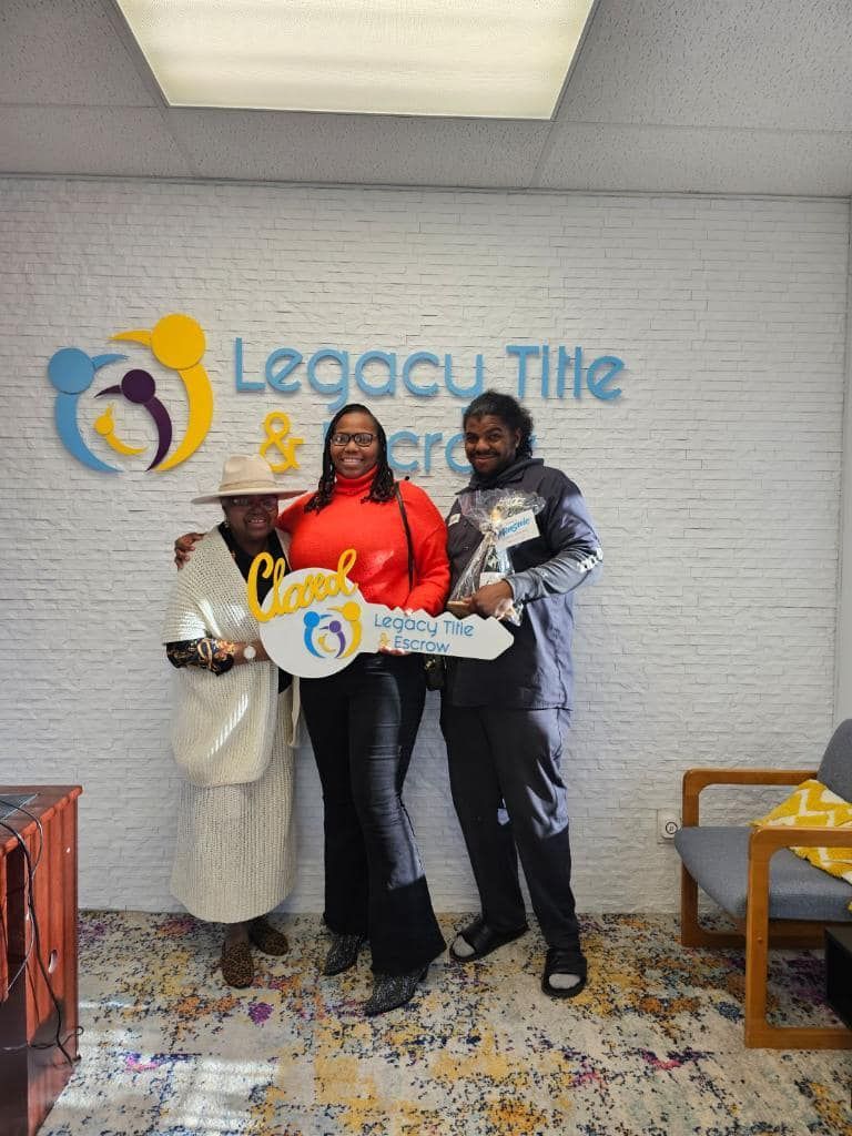 Three women are standing next to each other in a room holding keys.