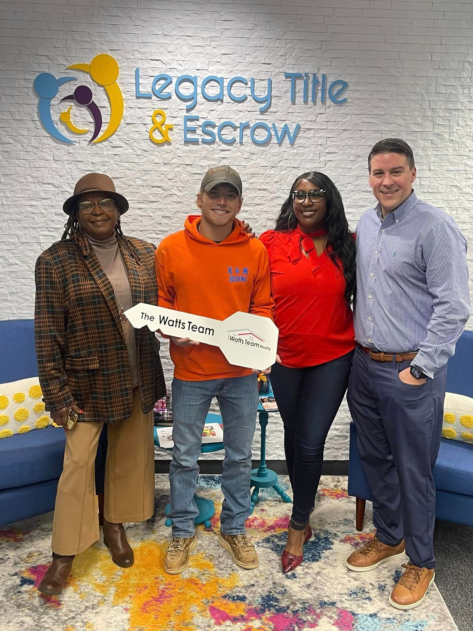 A group of people standing next to each other holding a key.