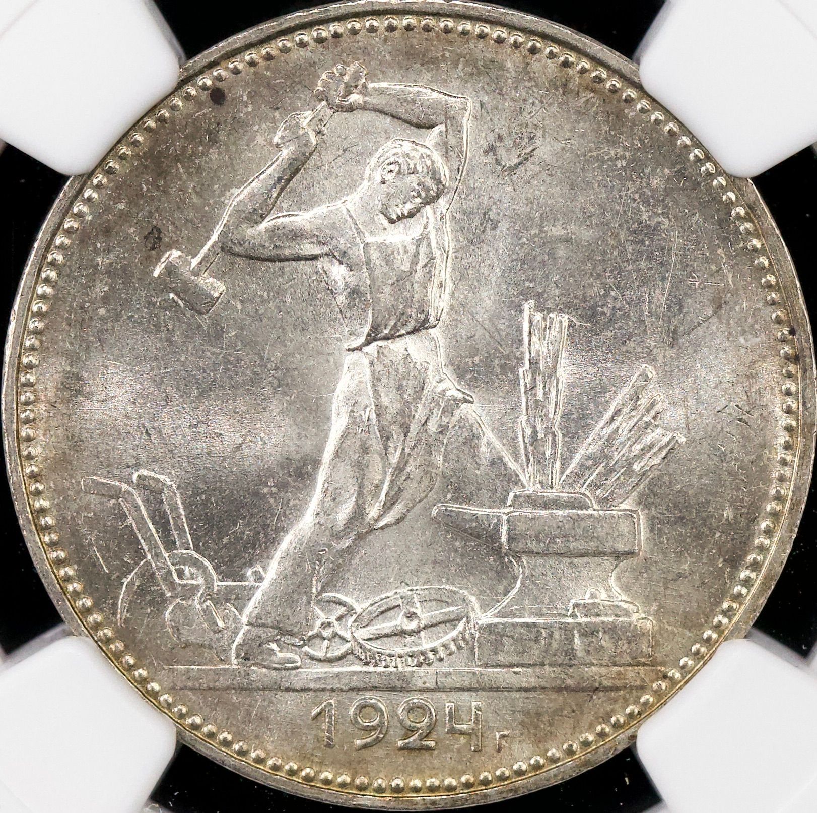 A silver coin with the year 1924 on it