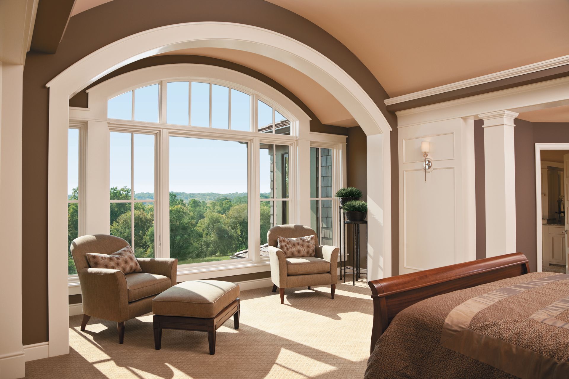 A bedroom with a bed , chairs and a large window