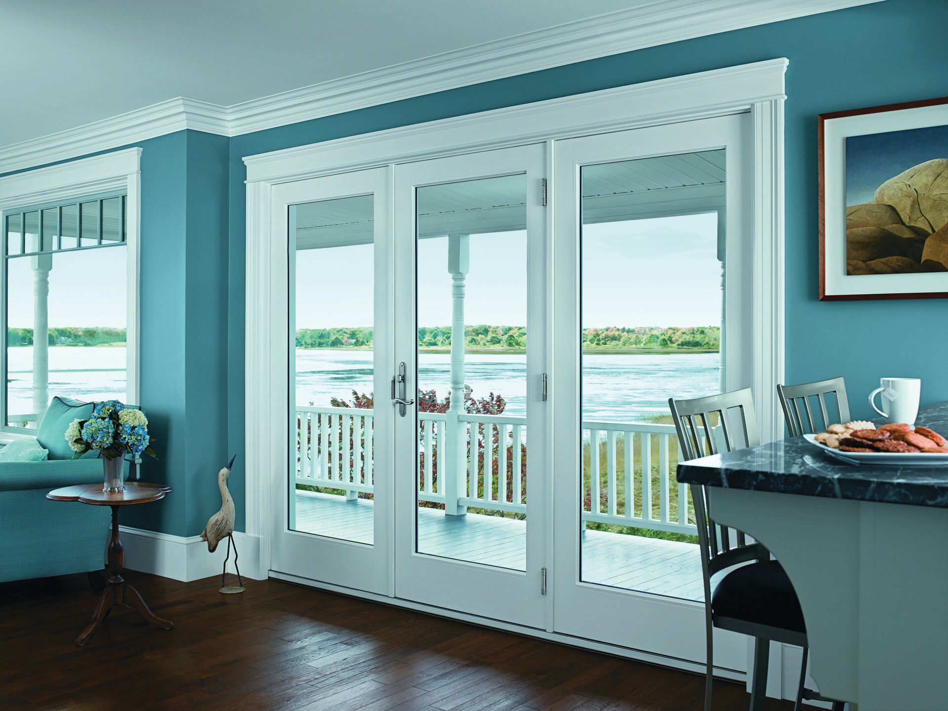 A living room with blue walls and white sliding glass doors
