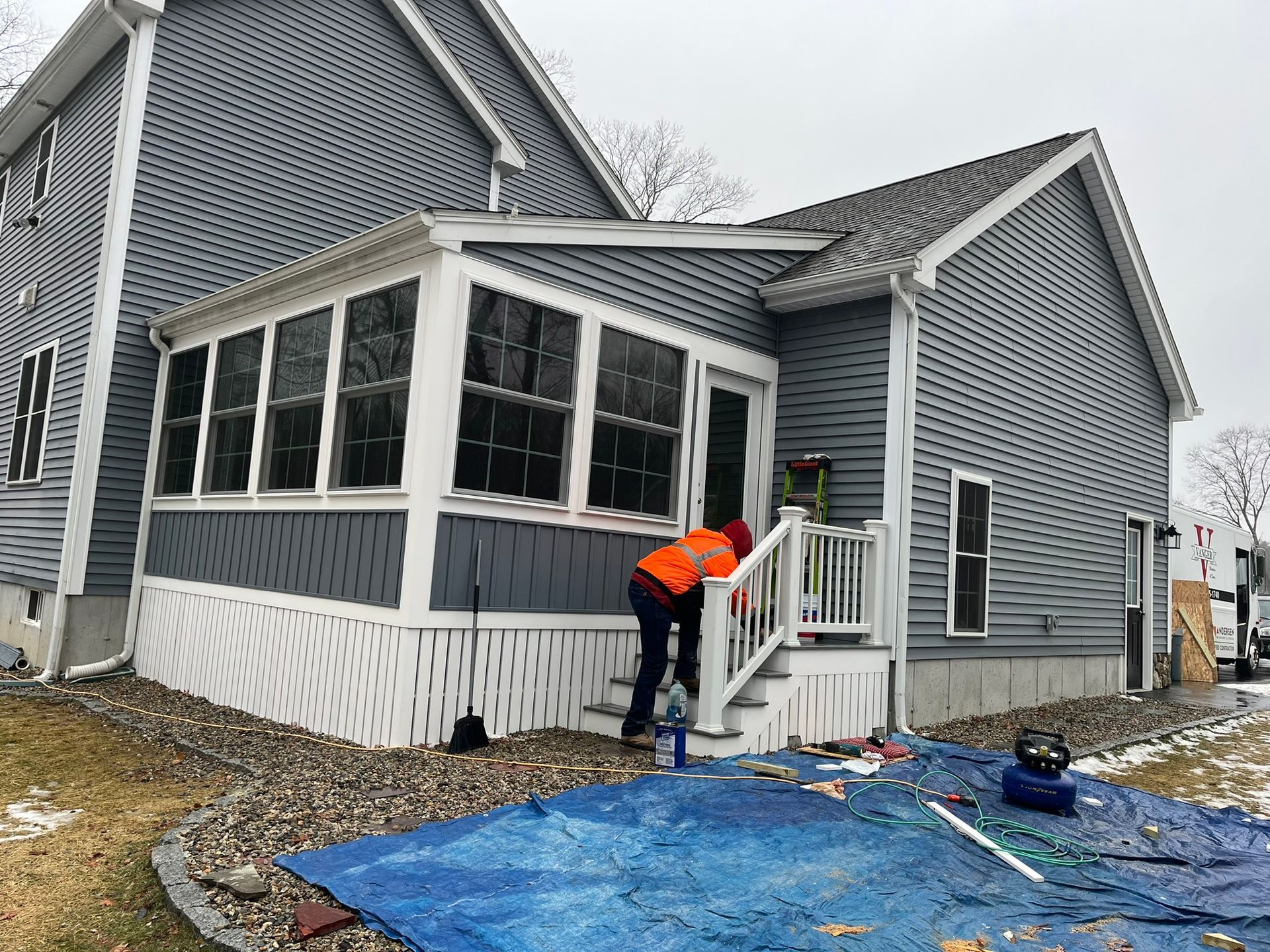 A man is painting the side of a house.