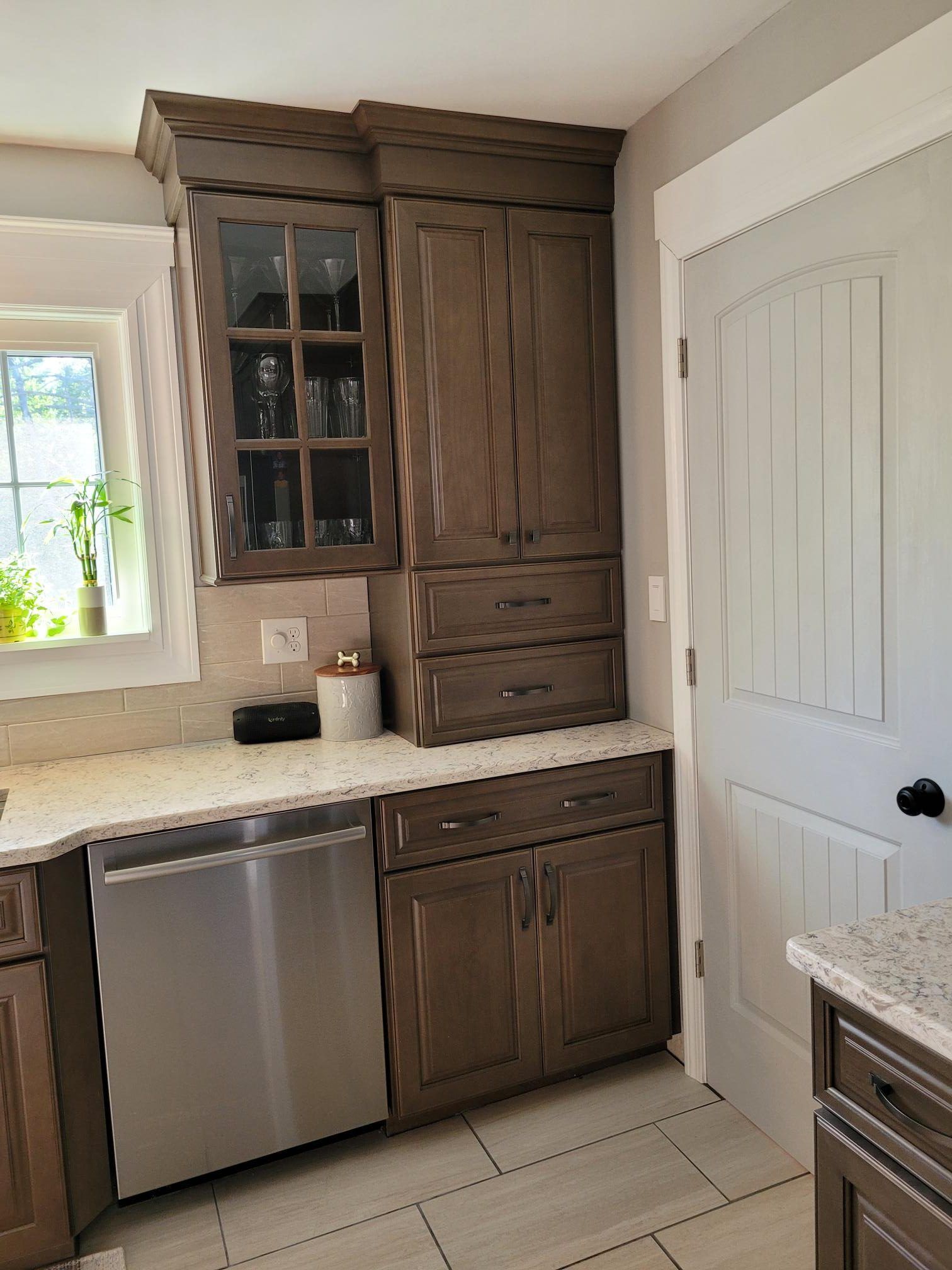 A kitchen with stainless steel appliances and wooden cabinets.