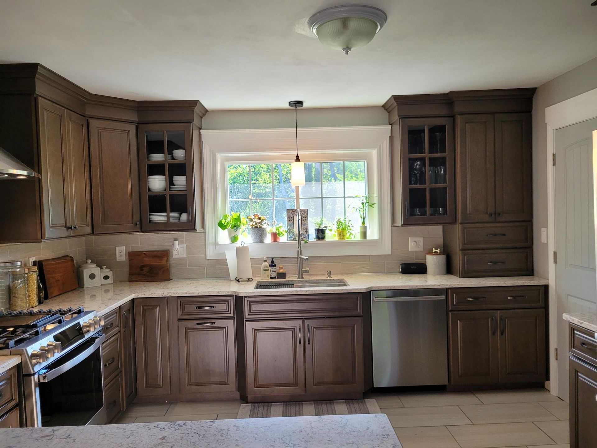 A kitchen with brown cabinets and stainless steel appliances