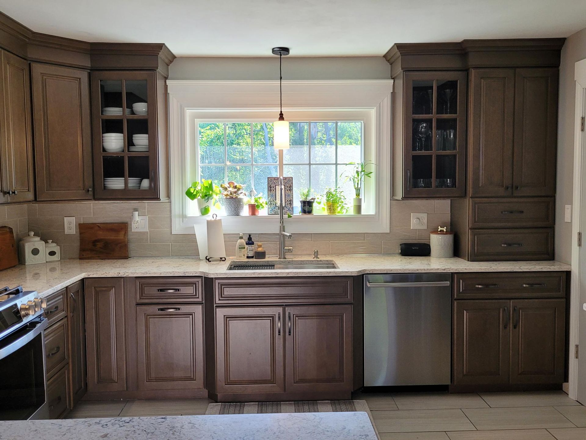 A kitchen with brown cabinets and stainless steel appliances