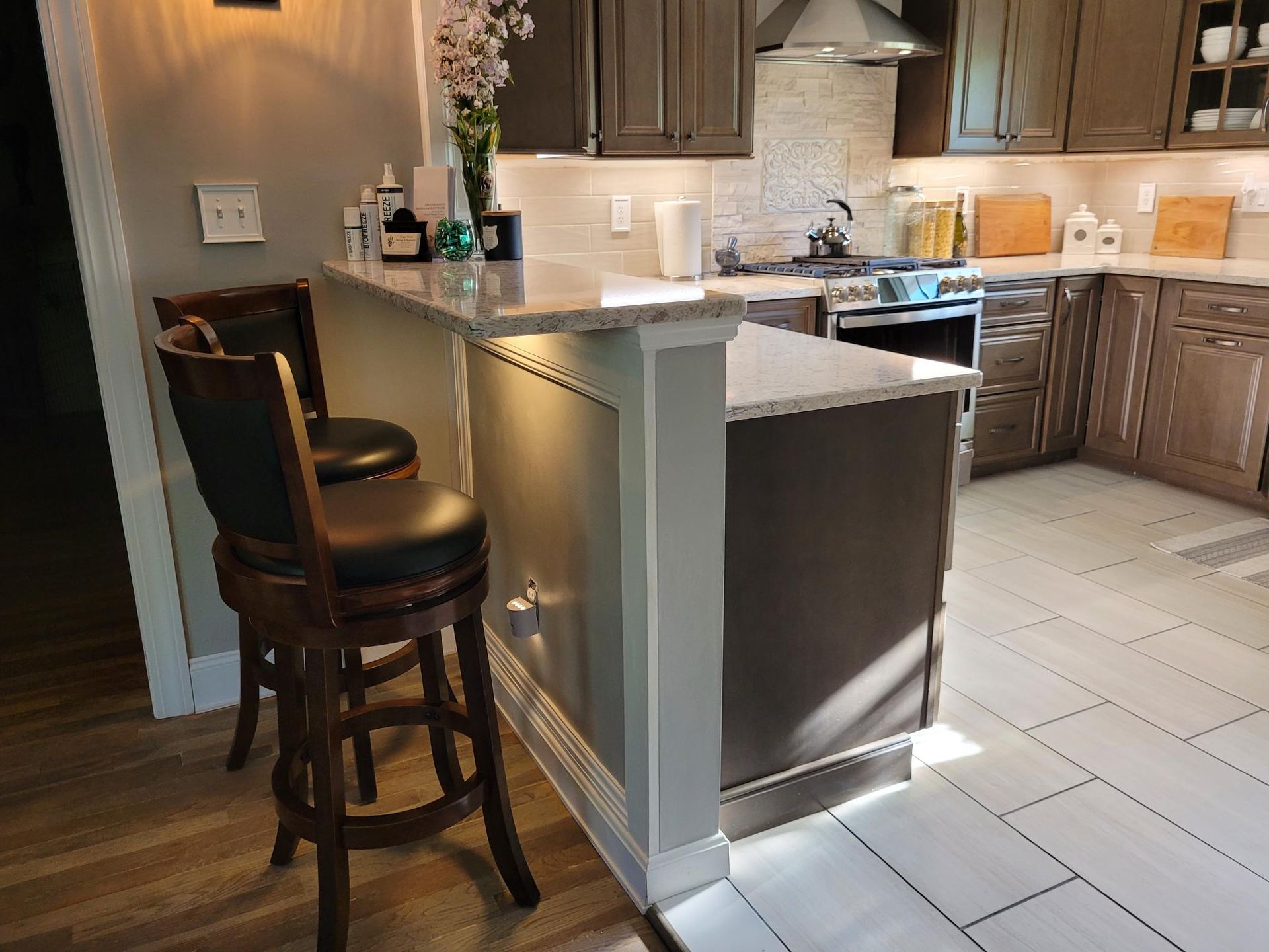 A kitchen with a bar and stools in it