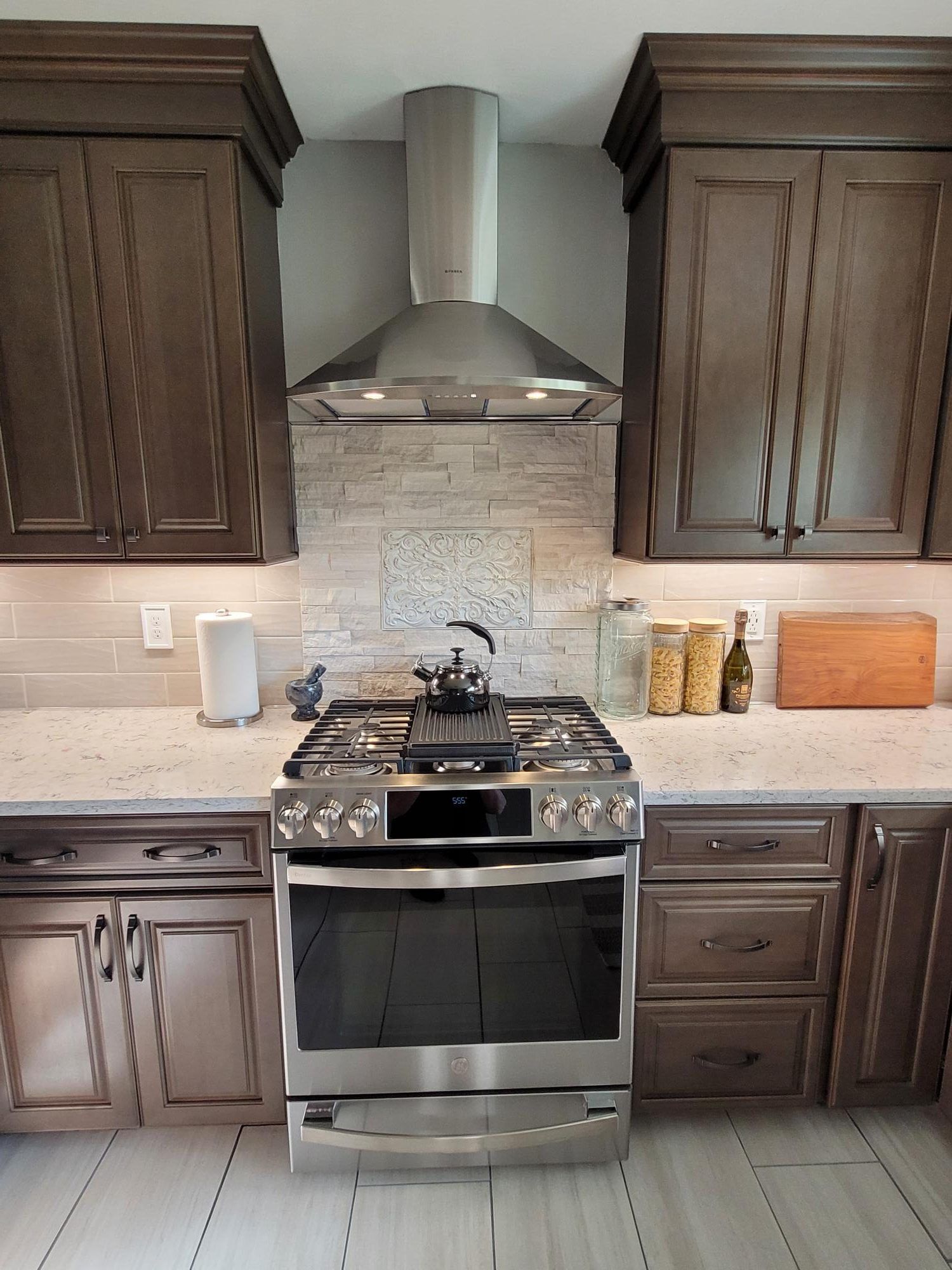 A kitchen with stainless steel appliances and wooden cabinets