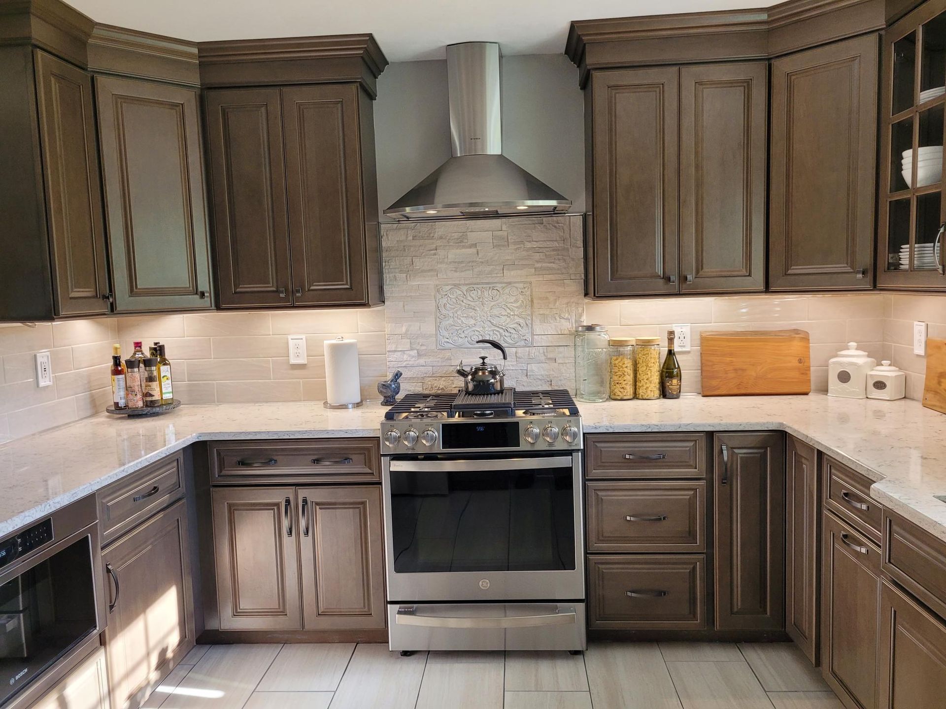 A kitchen with stainless steel appliances and wooden cabinets