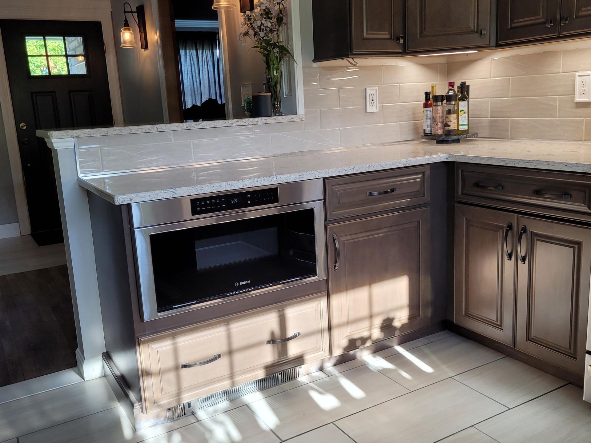 A kitchen with stainless steel appliances and granite counter tops.