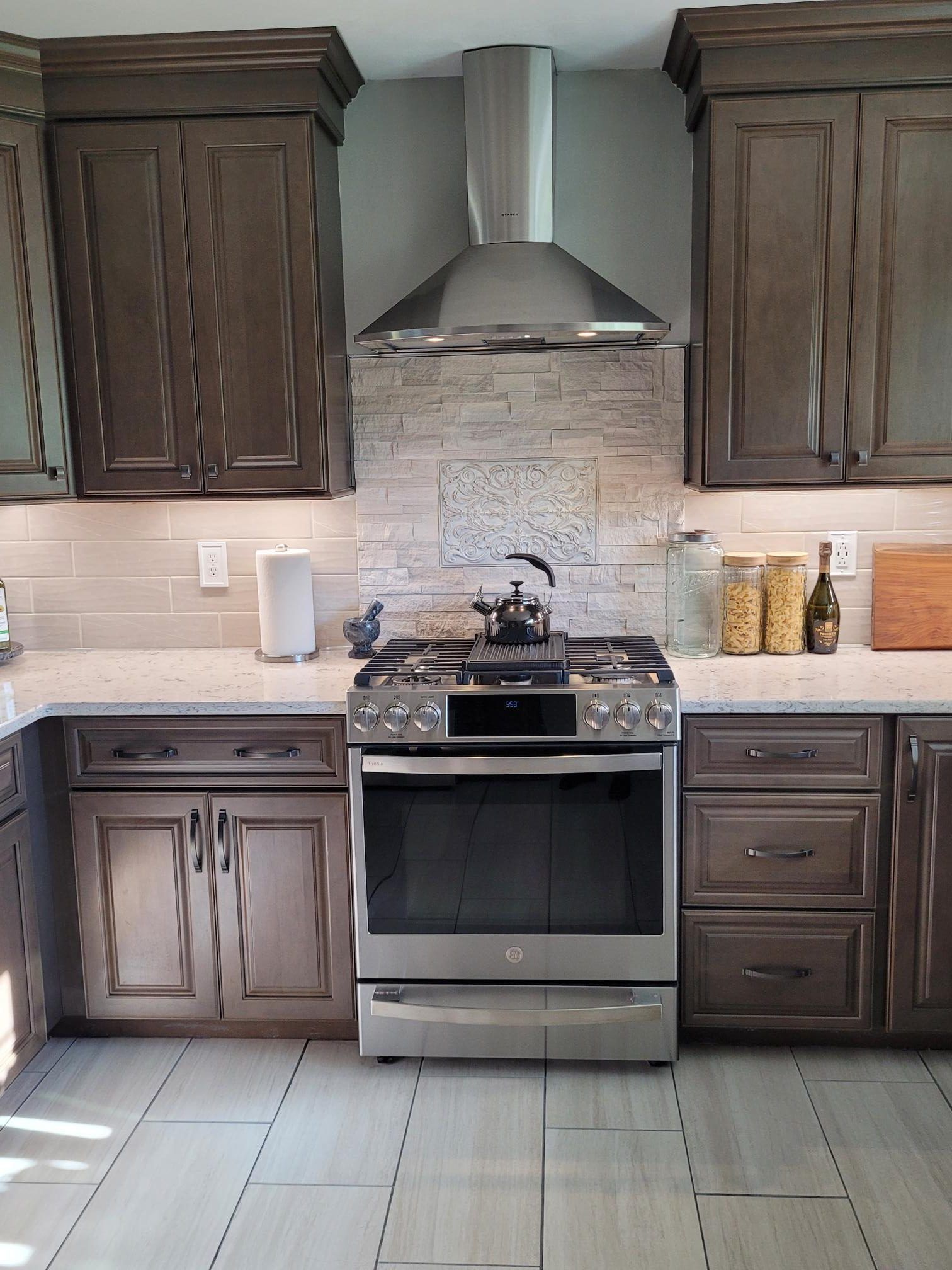 A kitchen with stainless steel appliances and wooden cabinets