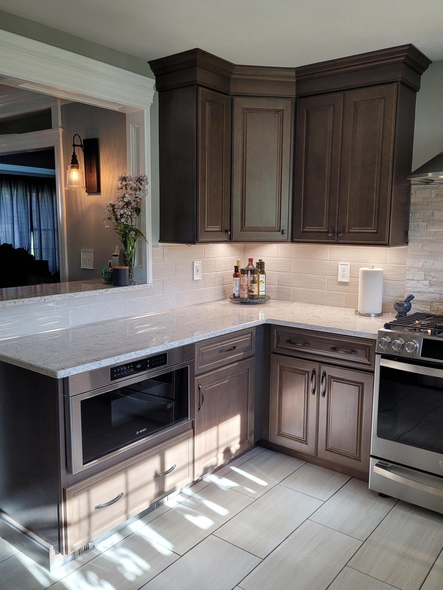 A kitchen with stainless steel appliances and wooden cabinets.