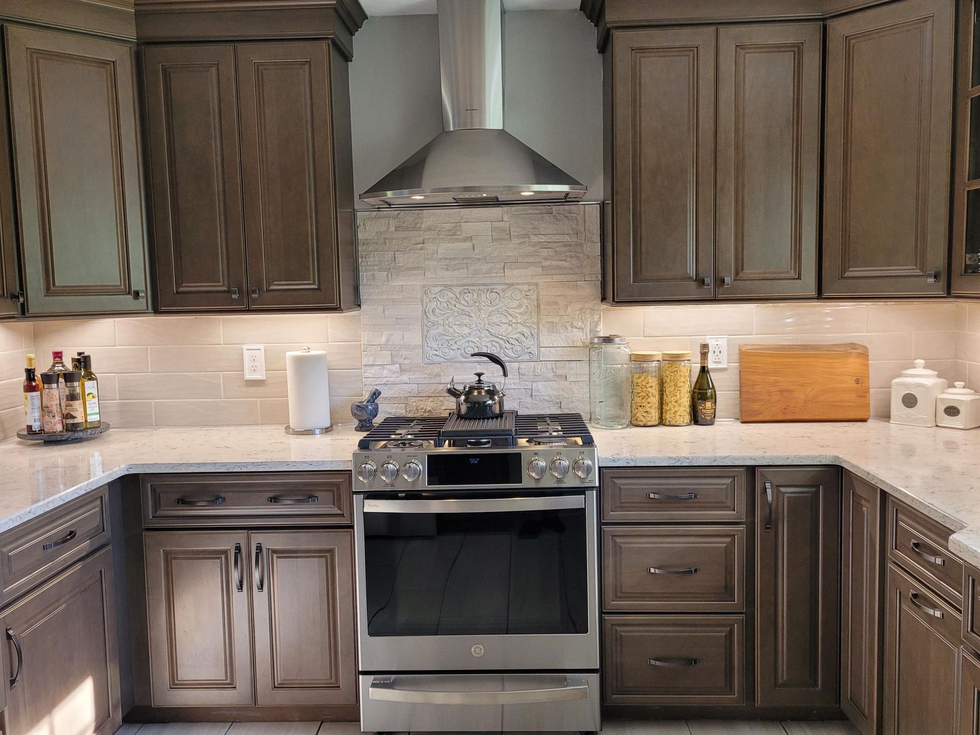 A kitchen with stainless steel appliances and wooden cabinets